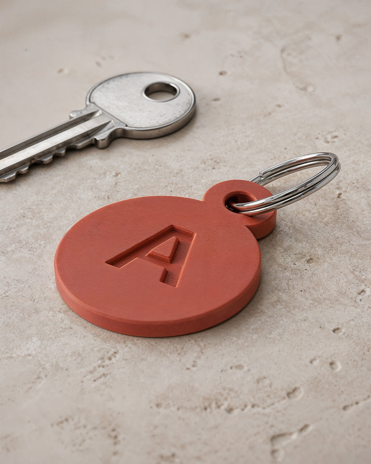 AI-assisted photorealistic visualization of the original ShapEVO Initial Tile keychain concept